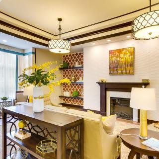 A modern living room with elegant lighting, a cozy fireplace, and stylish decor.