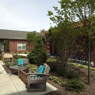 A tranquil garden area with outdoor seating and lush landscaping.
