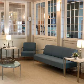 A cozy and modern living space featuring a blue sofa and stylish furniture.