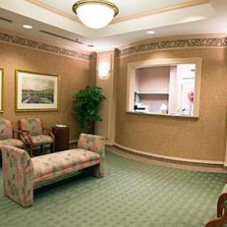 A comfortable waiting room featuring floral-patterned seating and a pleasant interior design.