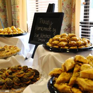 A display of various pastries and baked goods on a buffet table.