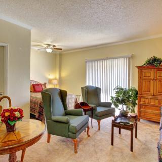 A cozy living room featuring comfortable seating, natural lighting, and tasteful decor.