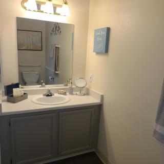 A clean and simple bathroom with a mirror above the sink.