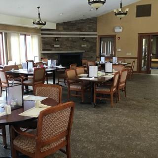 An empty restaurant dining area with neatly arranged tables and chairs.