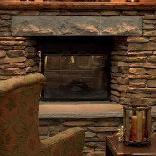 A warm and inviting stone fireplace adds charm to the living room.