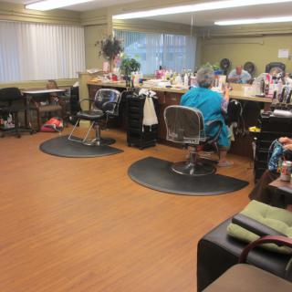 An interior view of a hair salon with chairs and mirrors.