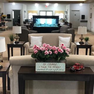 A well-decorated lobby with comfortable seating and floral arrangements.