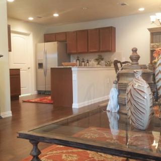 A modern open floor plan featuring a kitchen with stainless steel appliances and a living area with elegant dcor.
