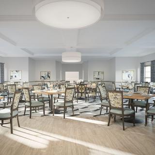 A modern dining room with neatly arranged tables and chairs, illuminated by large overhead lights.