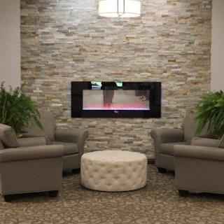 A cozy seating area featuring a modern fireplace and stylish decor.