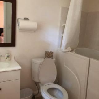 A compact bathroom with a toilet, sink, and bathtub.