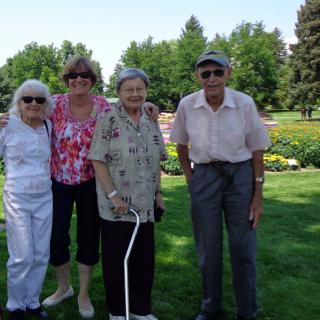 A group of elderly people enjoying a sunny day in the park.