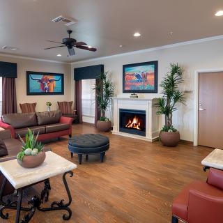 A cozy and well-decorated living room with a fireplace and comfortable seating.