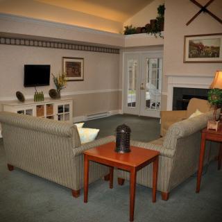 A cozy living room featuring a comfortable sofa, coffee table, and fireplace, creating a welcoming atmosphere.