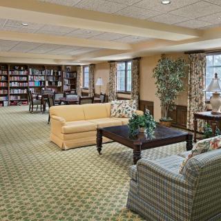 A comfortable living room with sofas, a coffee table, and bookshelves.
