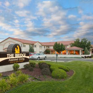 The Bridge Assisted Living facility under a partly cloudy sky.