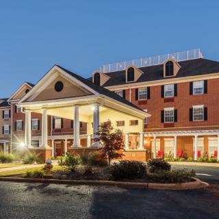 An elegant hotel building illuminated in the evening.