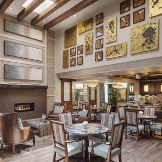 A modern dining area featuring elegant furniture and artistic wall decor.