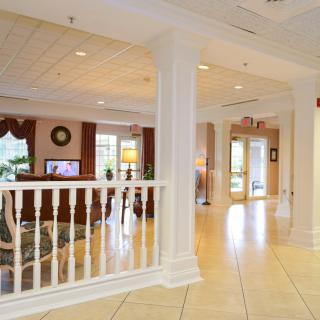 A spacious and elegantly designed lobby area with columns and comfortable seating.