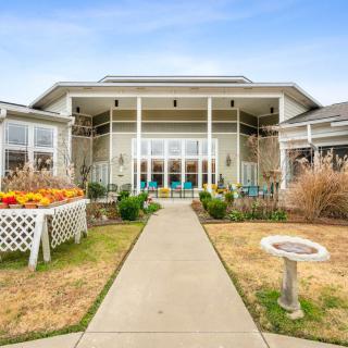 A beautiful residential building with a landscaped garden and walkway.
