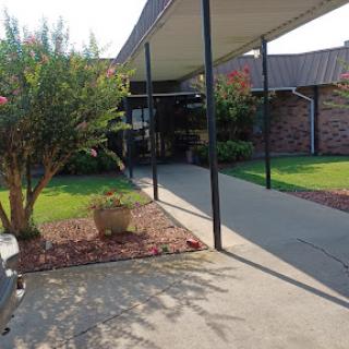 A view of a welcoming home entrance with a landscaped yard.