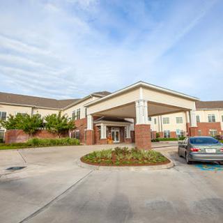 The welcoming entrance of a hotel with a spacious parking area.