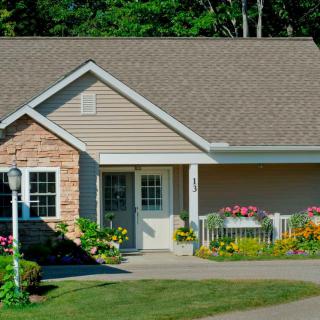 A charming suburban house with a well-maintained garden and front yard.