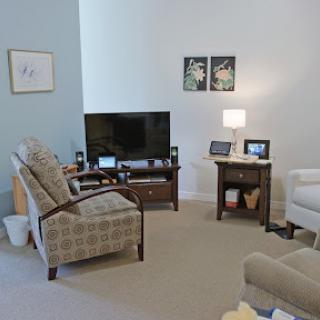 A cozy living room featuring a television, comfortable seating, and tasteful decor.