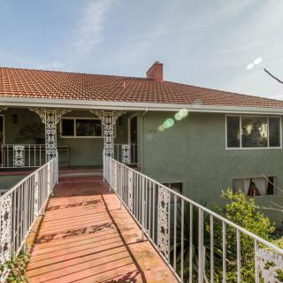 A residential house with a walkway bridge leading to the entrance.