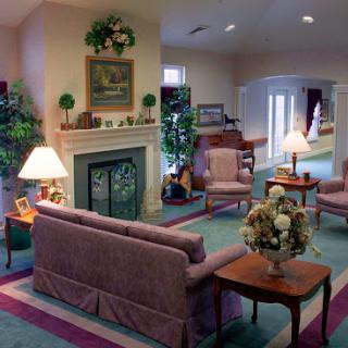 A cozy living room with comfortable seating, decorative plants, and inviting lighting.