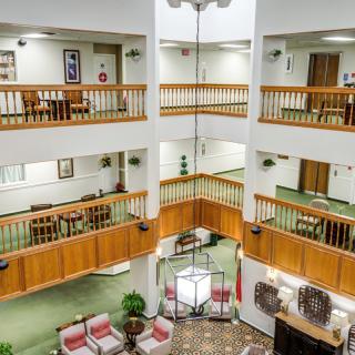 A modern atrium featuring multiple balconies overlooking a spacious lobby.