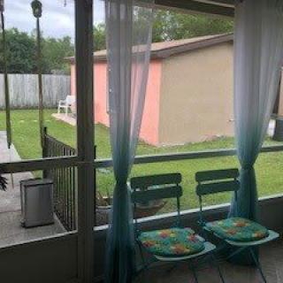 A cozy patio with two chairs overlooking a backyard garden.