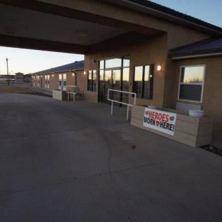 Exterior view of a building entrance with a covered walkway and ramp.