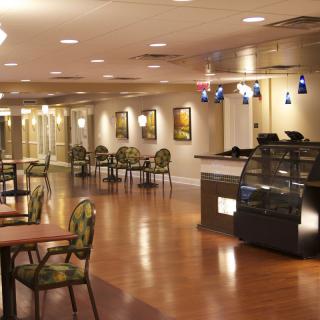 An empty cafe with elegant furniture and warm lighting.
