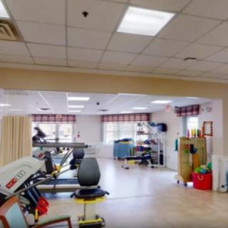 A rehabilitation therapy room equipped with exercise machines and tools.