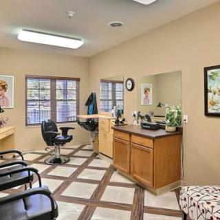 A cozy hair salon interior with chairs and mirrors.