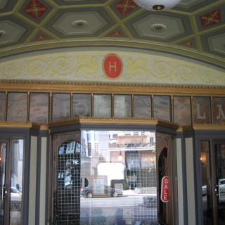 The vintage entrance of a theater with decorative architecture.