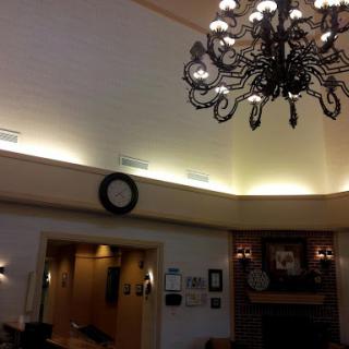 An elegantly designed interior featuring a decorative chandelier and ambient lighting.