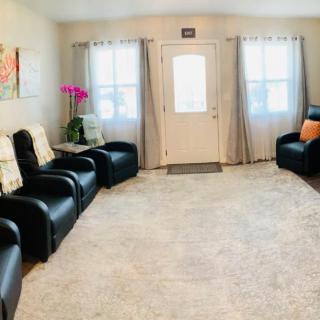 A cozy living room with leather seating and bright decor.