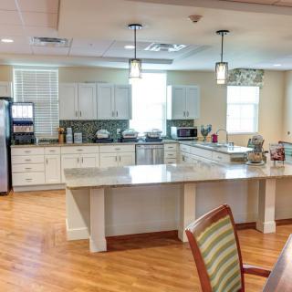 A modern kitchen interior with white cabinets and a spacious countertop.