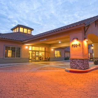 A well-lit hotel entrance during the evening with a welcoming ambiance.