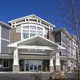 A modern commercial building with a prominent entrance and architectural details.