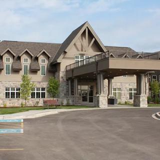 A large building with a prominent entrance and surrounding landscaping.