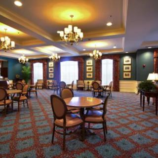 Elegant dining room with chandeliers and classic decor.