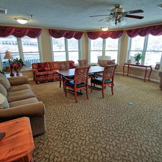 A spacious living room with comfortable seating and large windows.