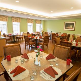 A well-arranged dining area with neatly set tables and comfortable chairs.