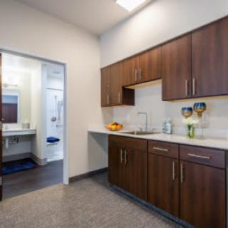 A modern kitchen interior with wooden cabinets and a sink.