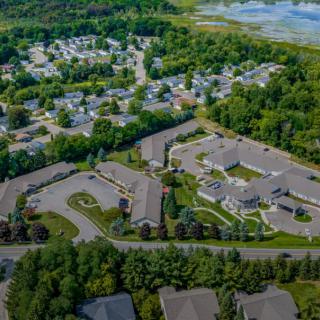 Aerial view of a suburban residential area surrounded by greenery.