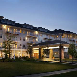 A well-lit residential building in the evening.