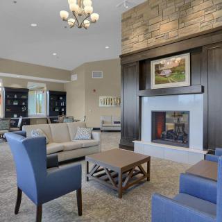 A modern living room featuring a cozy fireplace, stylish furniture, and elegant decor.